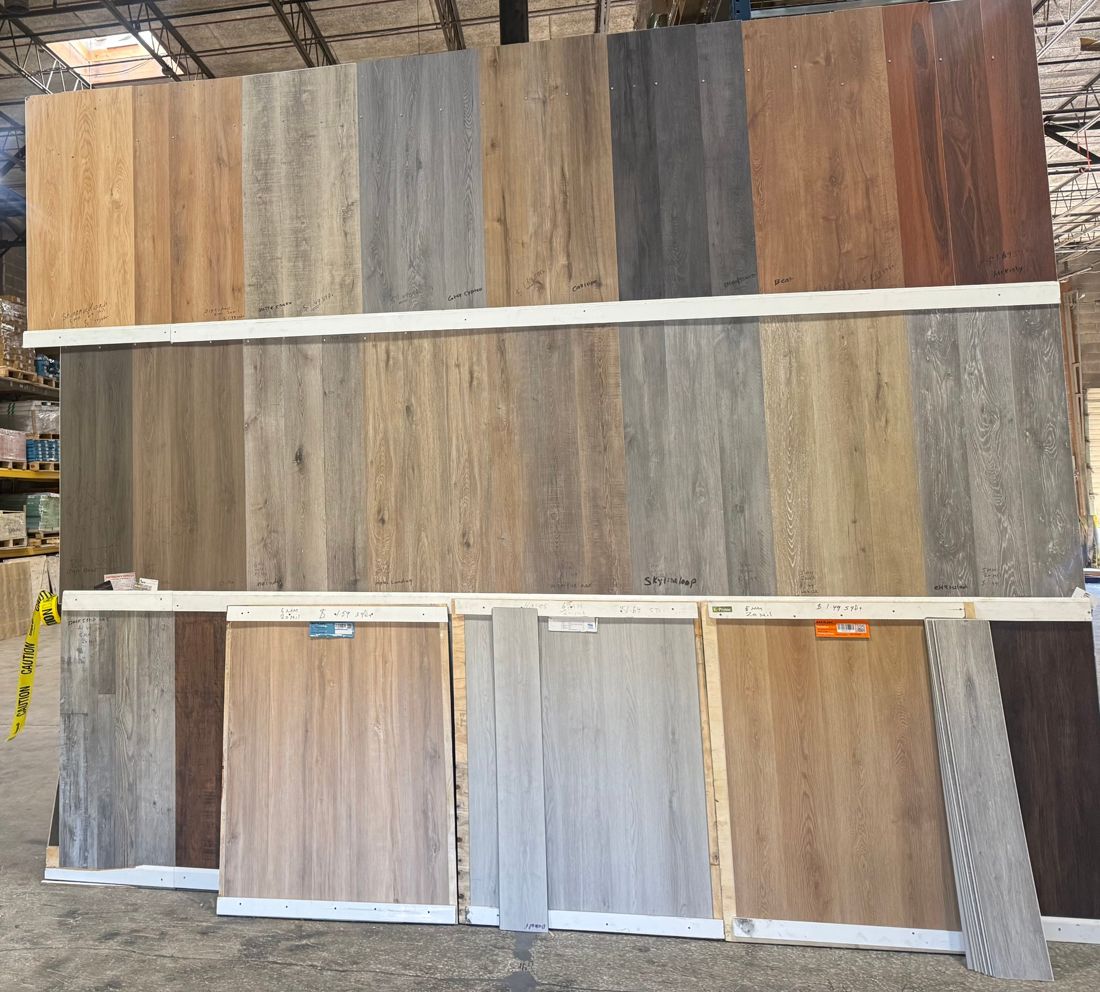 Wall of LVP samples with names and prices written on each