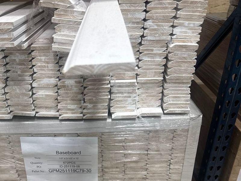Pallet of primed ½ by 3½ inch baseboard